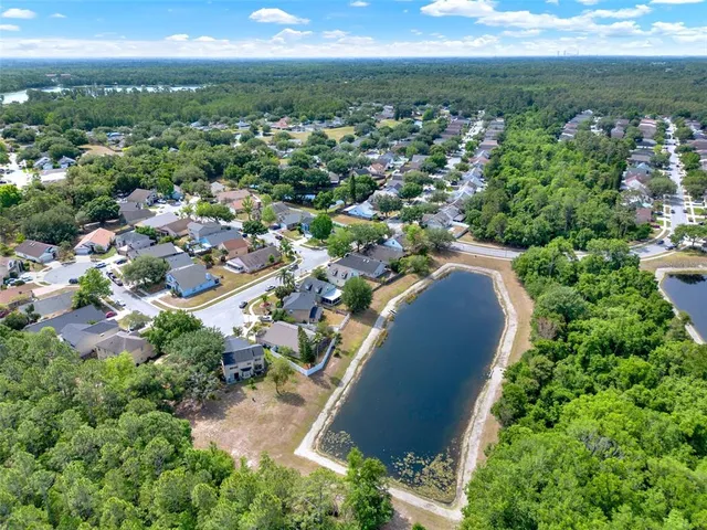 an aerial view of a house with a yard