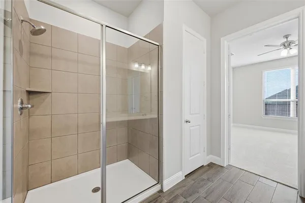 a bathroom with a shower and a sink