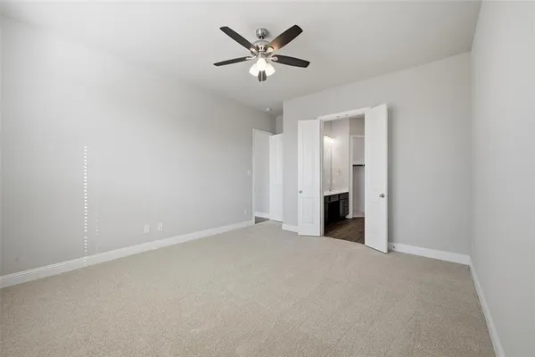 a view of an empty room with a ceiling fan