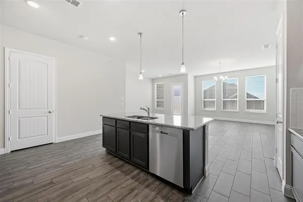 a view of a kitchen with stainless steel appliances granite countertop a sink and cabinets