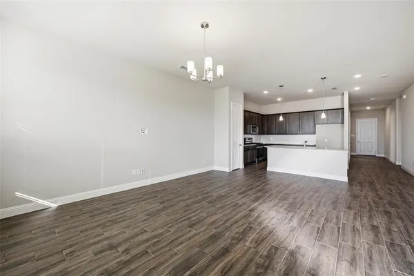 a view of kitchen with granite countertop cabinets and wooden floor