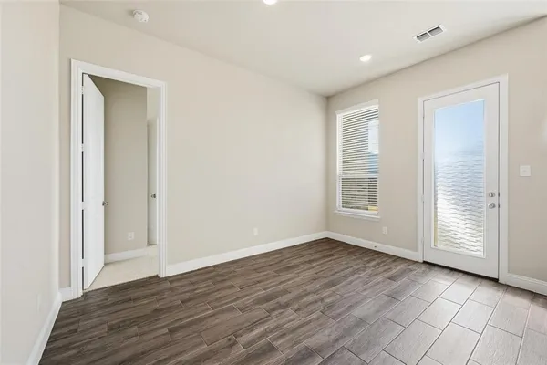 wooden floor in an empty room with a window
