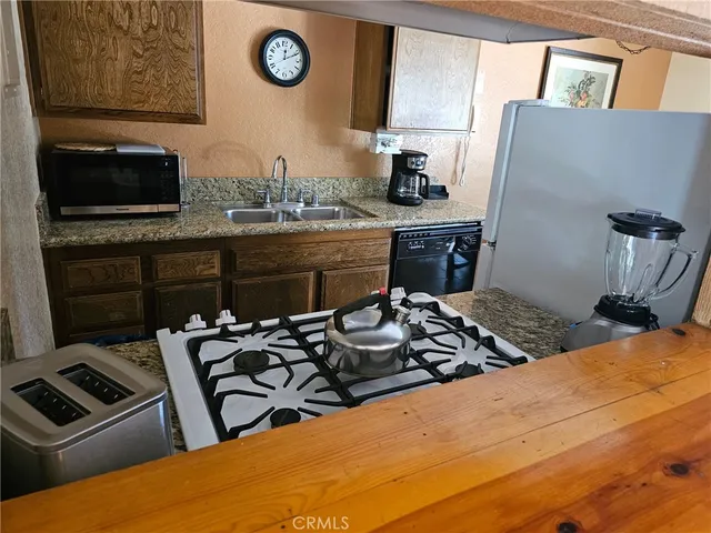 a kitchen with a stove a sink and a microwave