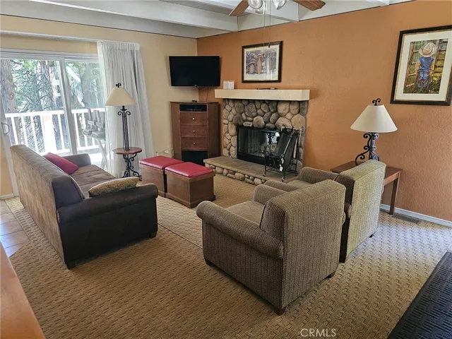 a living room with furniture flat screen tv and a fireplace