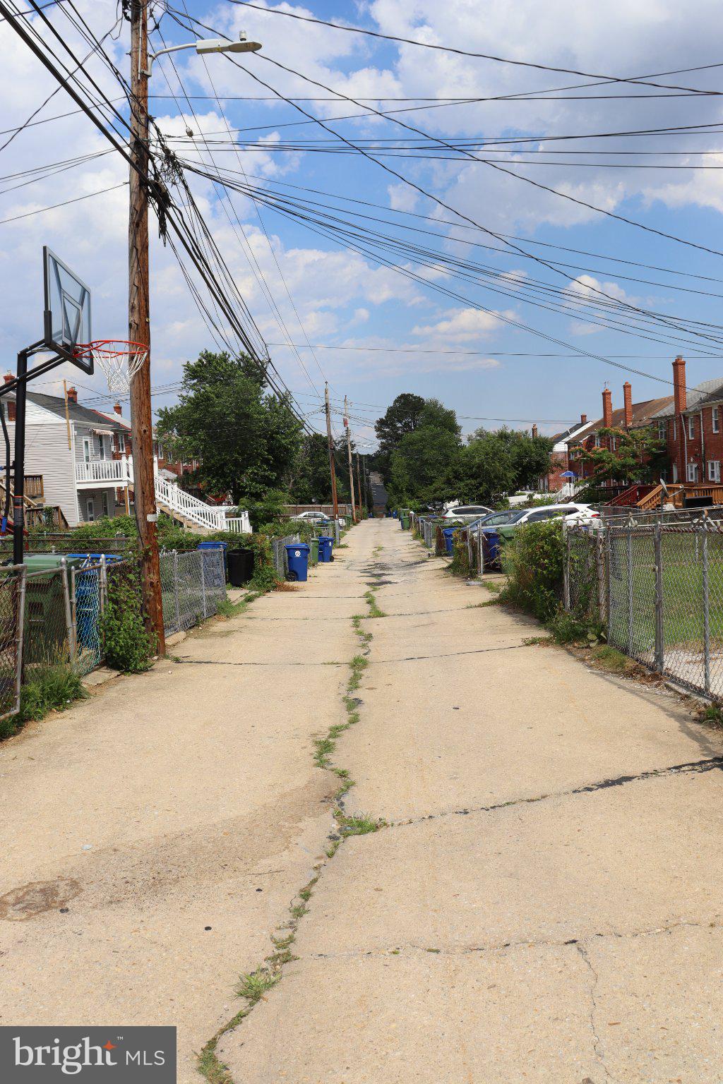 1328 Cedarcroft Road Baltimore, MD 21239 - Photo 12 of 39 Quiet alleyway under blue skies.