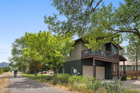 front view of a house with a tree