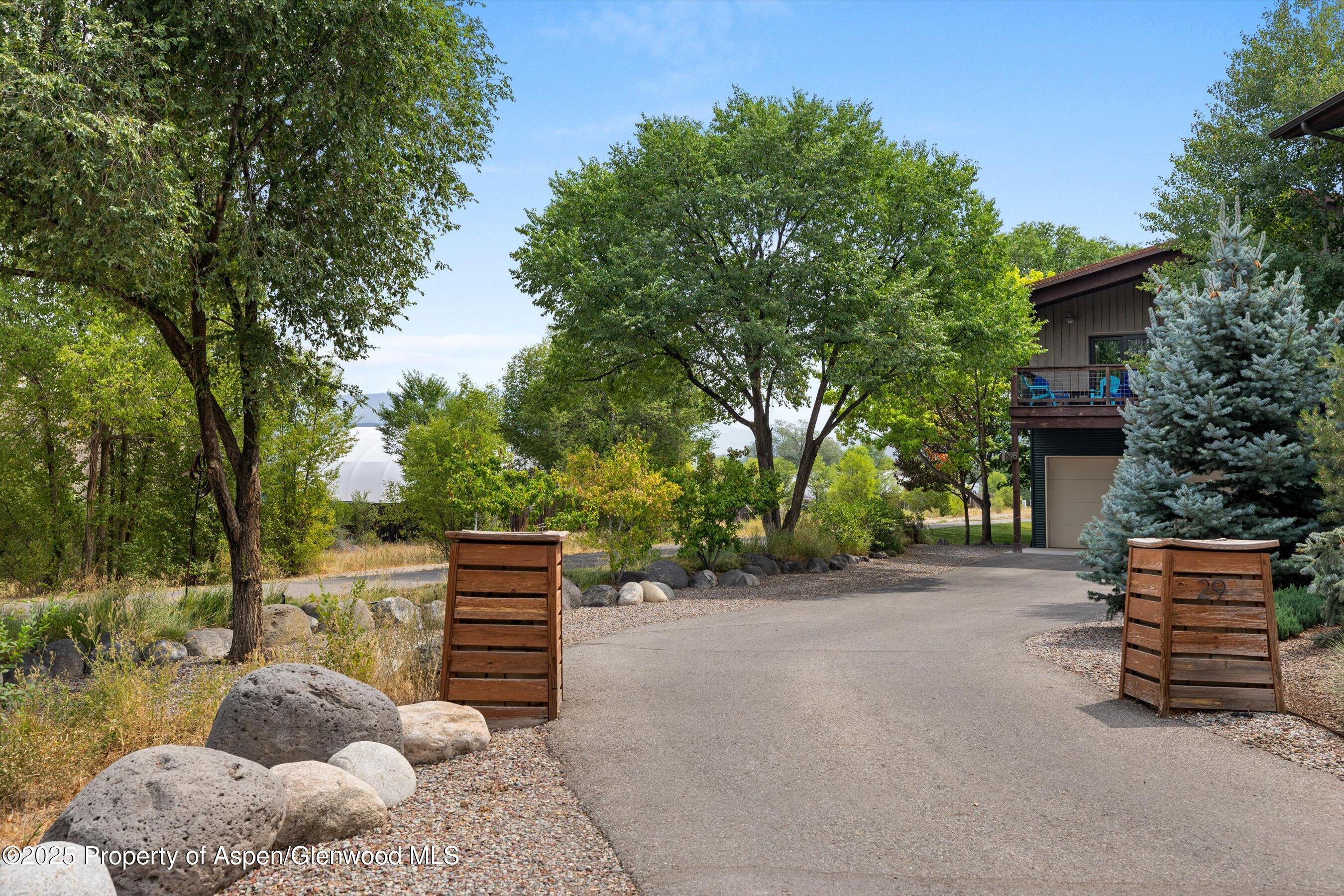 296-298 North 7th Street Carbondale, CO 81623 - Photo 2 of 11 a backyard of a house with barbeque oven and trees