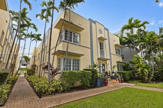 a view of a multi story building with a yard