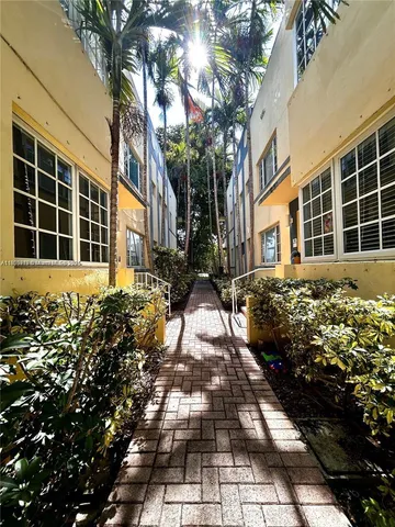 a view of a pathway with a flower garden