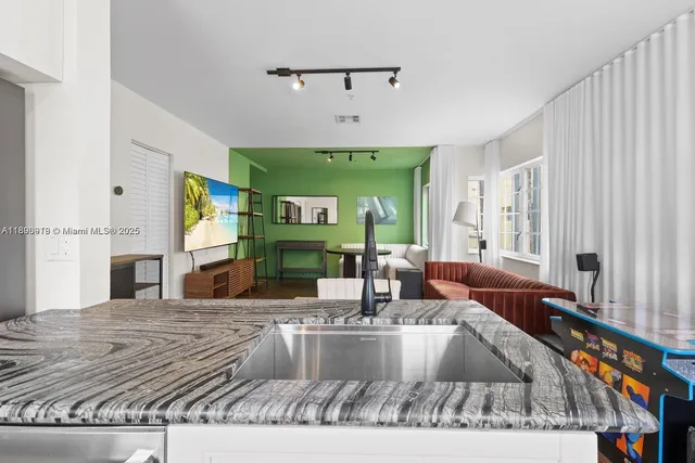a living room with fireplace furniture and a large window