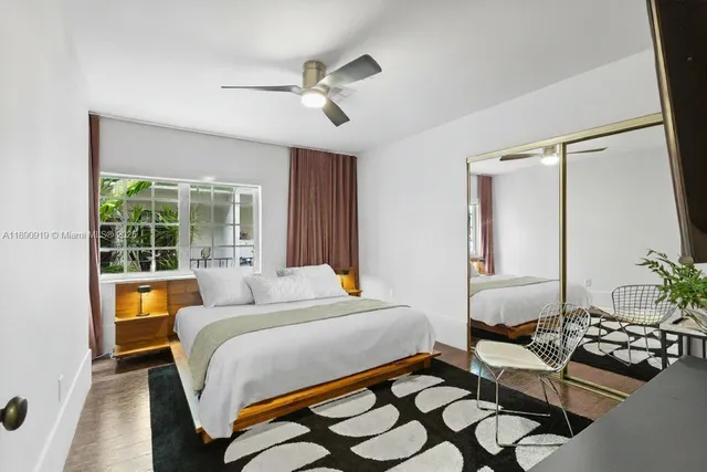 a bedroom with a bed and ceiling fan