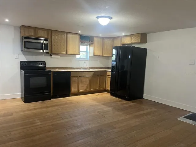a kitchen with stainless steel appliances granite countertop a refrigerator and a stove top oven