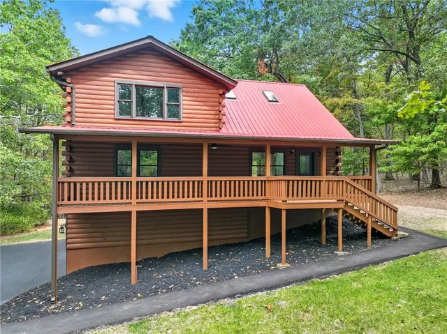 a view of a house with a deck and a yard