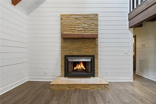 a living room with a wooden floor and a fireplace