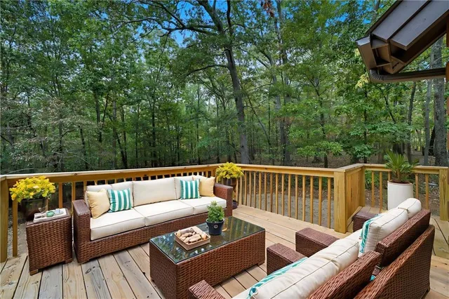 a roof deck with couches and wooden floor