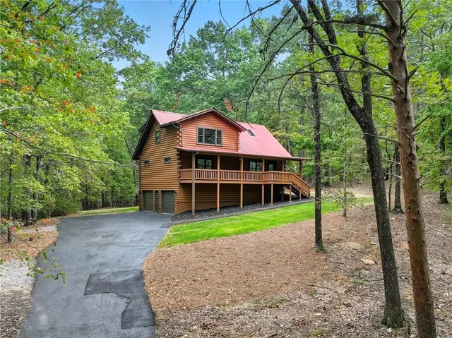 a view of a house with a yard and tree s