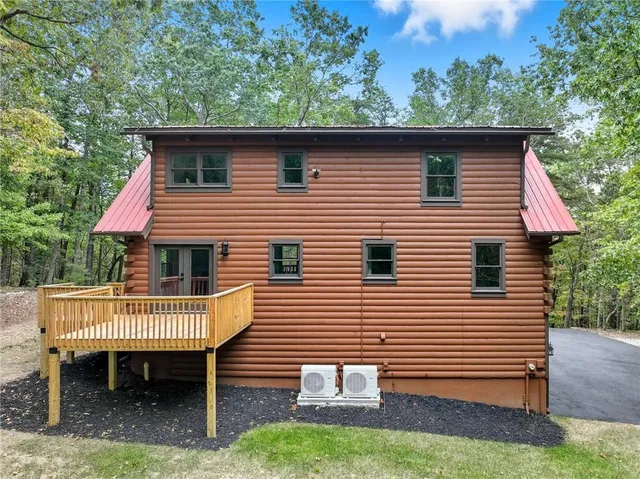 a view of a house with a yard and deck