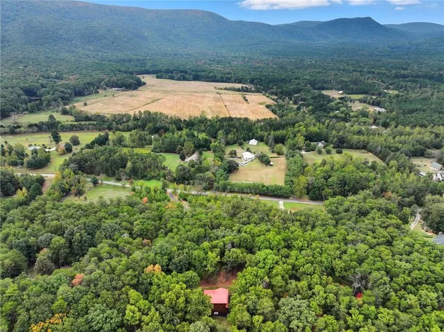 a view of a lake in middle of the green field and covered with green space