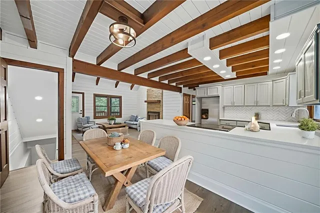 a kitchen with a sink a stove and chairs
