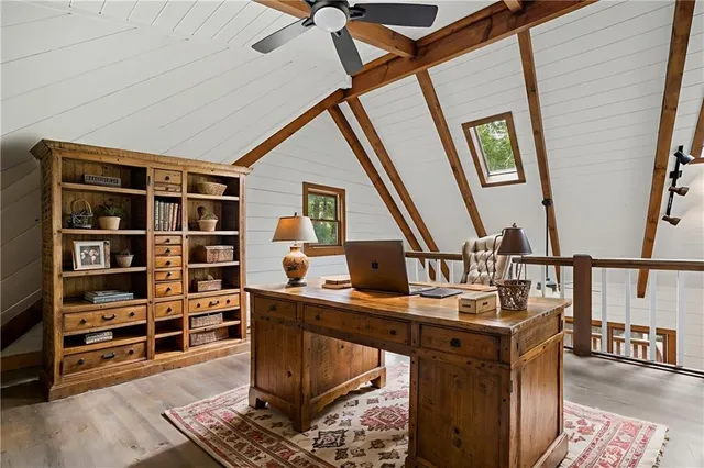 a view of workspace with wooden floor and stairs