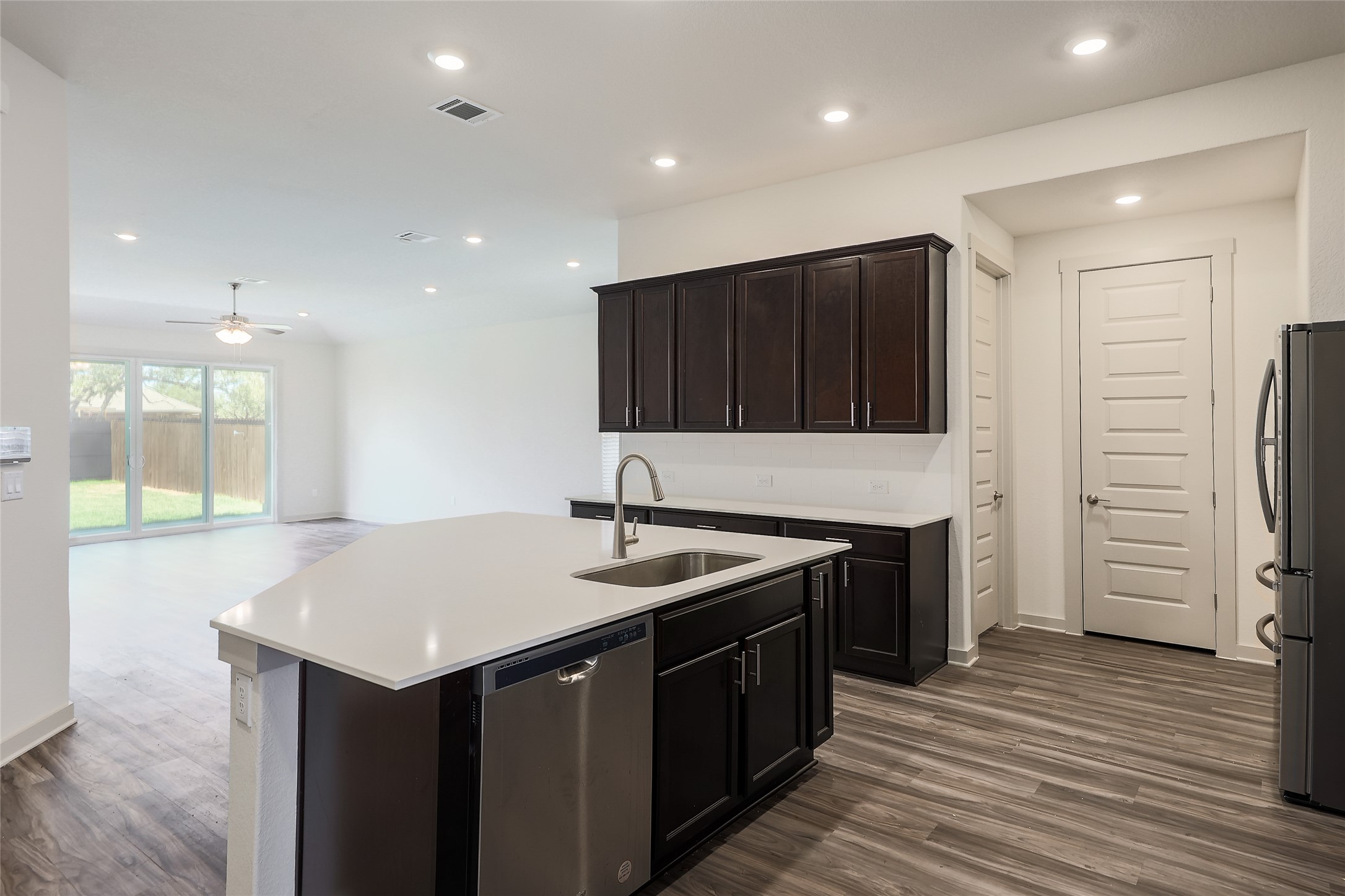 1917 Centerline Lane Georgetown, TX 78628 - Photo 4 of 29 Modern kitchen with an island sink, sleek cabinetry, and integrated appliances seamlessly flowing into the living area.