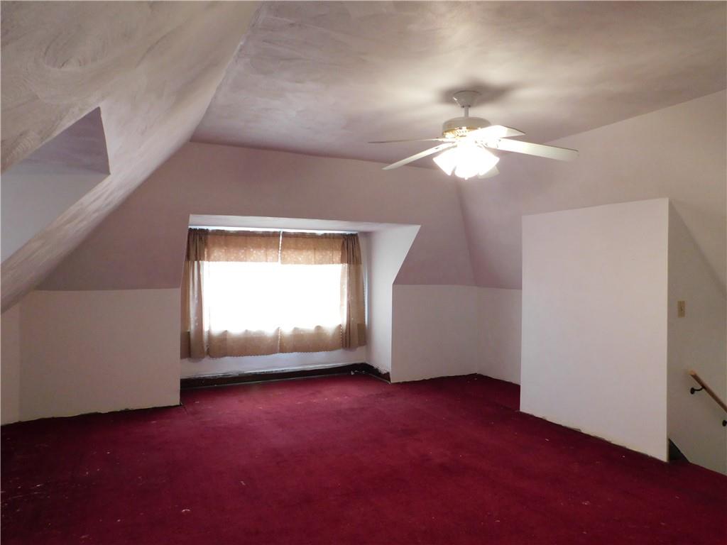 423 Alice Street Pittsburgh, PA 15210 - Photo 15 of 17 an empty room with a chandelier fan and windows