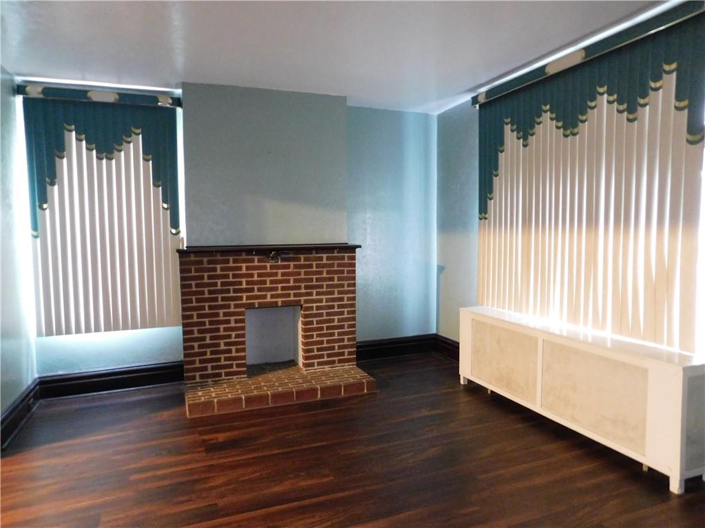 423 Alice Street Pittsburgh, PA 15210 - Photo 5 of 17 an empty room with wooden floor and windows