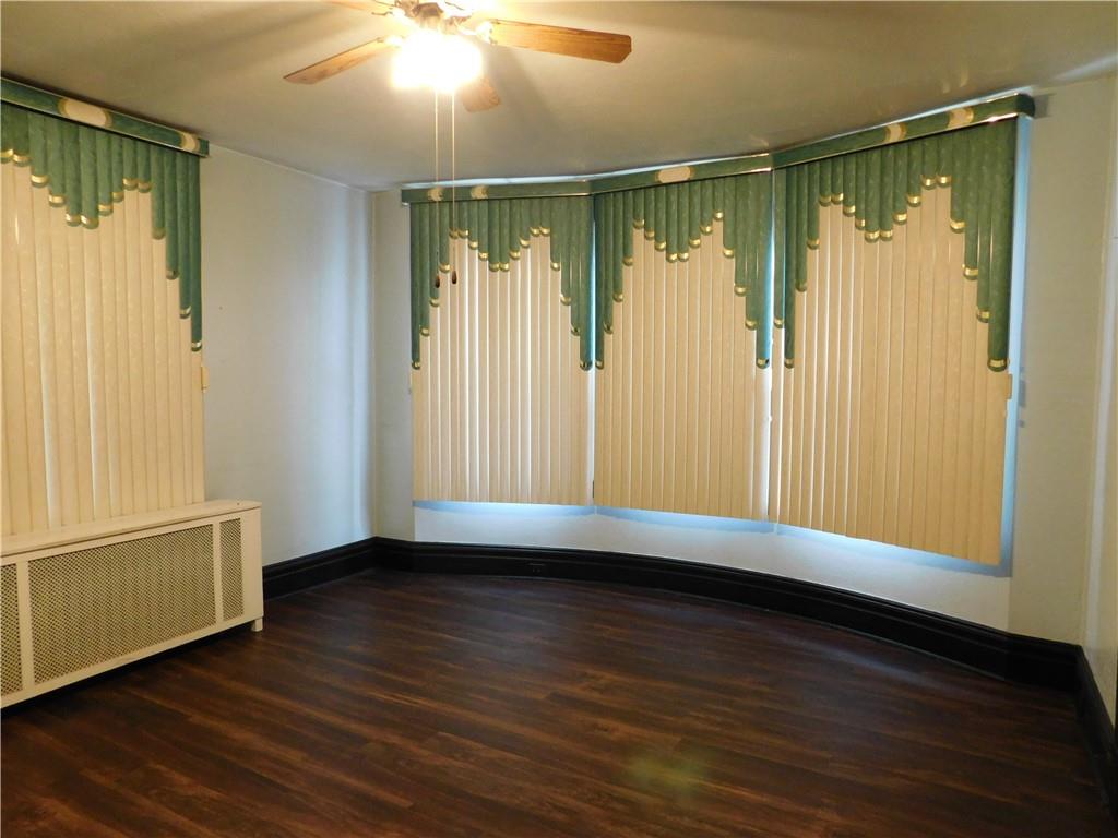 423 Alice Street Pittsburgh, PA 15210 - Photo 6 of 17 a view of an empty room with wooden floor and a window