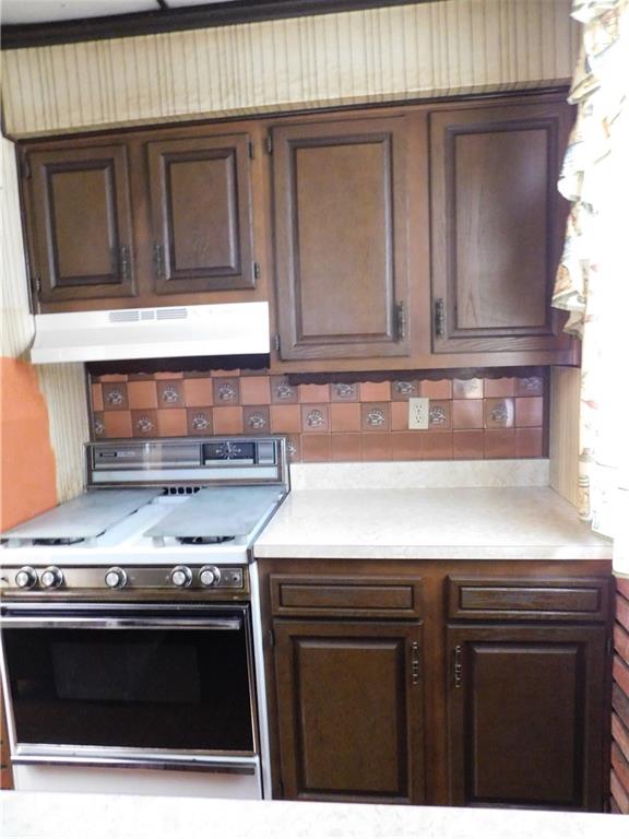 423 Alice Street Pittsburgh, PA 15210 - Photo 8 of 17 a kitchen with stainless steel appliances granite countertop a stove a microwave and oven