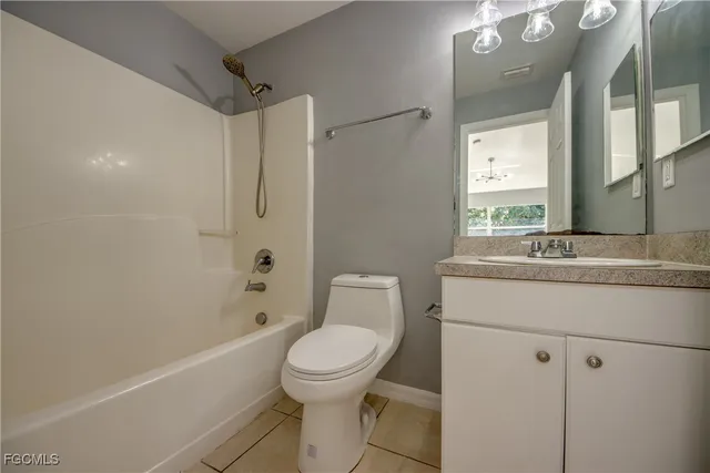 a bathroom with a toilet sink and shower