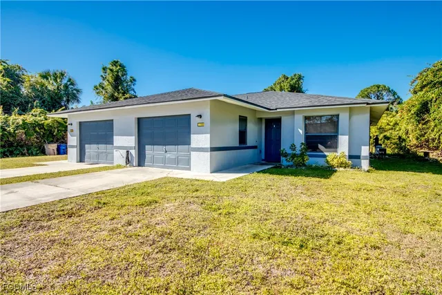 a view of a house with pool and chairs