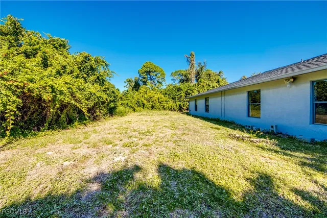 a view of backyard with large trees