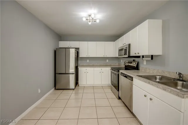 a kitchen with stainless steel appliances granite countertop a refrigerator sink and cabinets