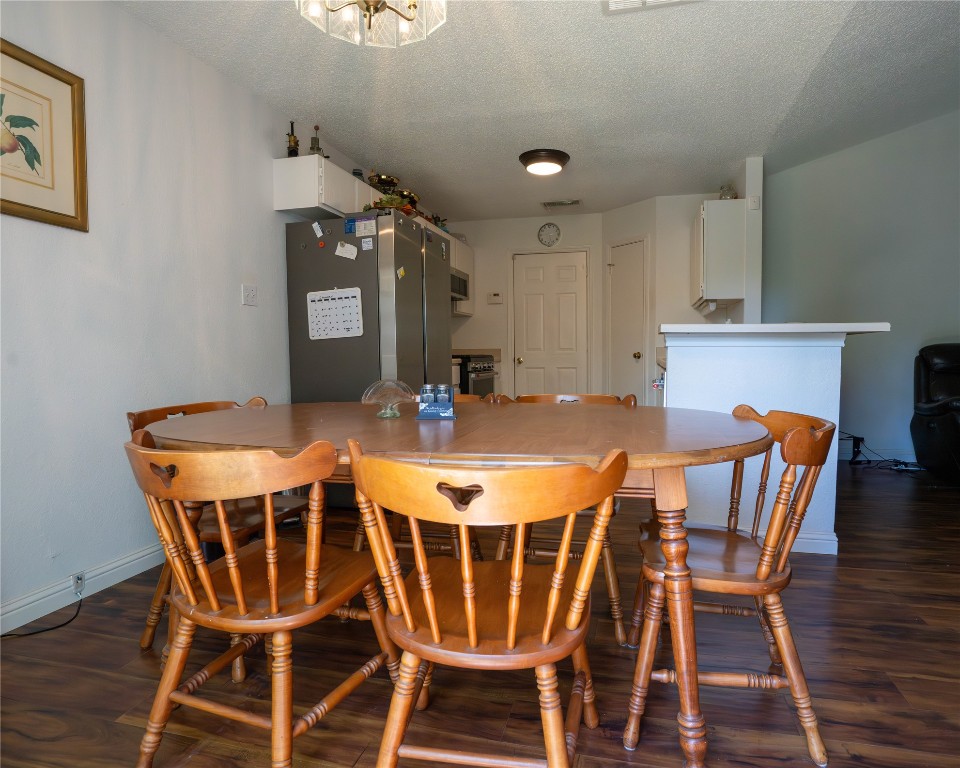 611 Penny Lane Cedar Park, TX 78613 - Photo 11 of 28 a view of a dining room with furniture and wooden floor