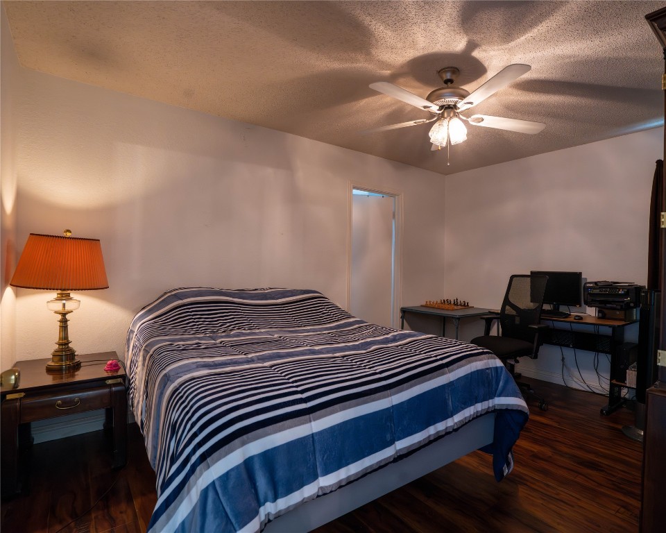 611 Penny Lane Cedar Park, TX 78613 - Photo 12 of 28 a bedroom with a bed and a chandelier