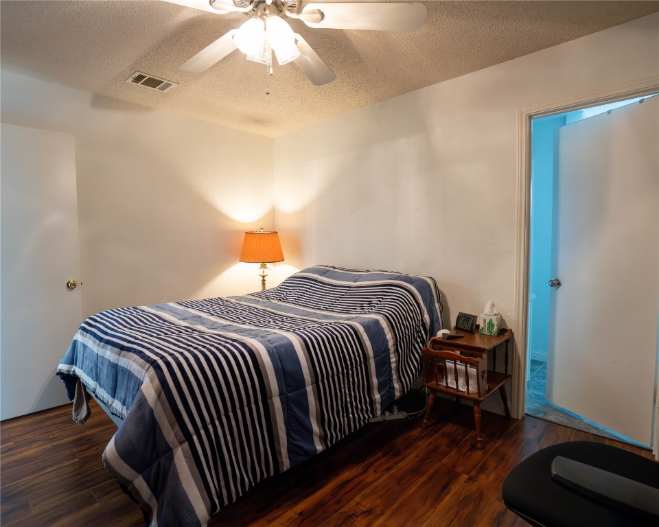 611 Penny Lane Cedar Park, TX 78613 - Photo 13 of 28 a bedroom with a bed and a chandelier
