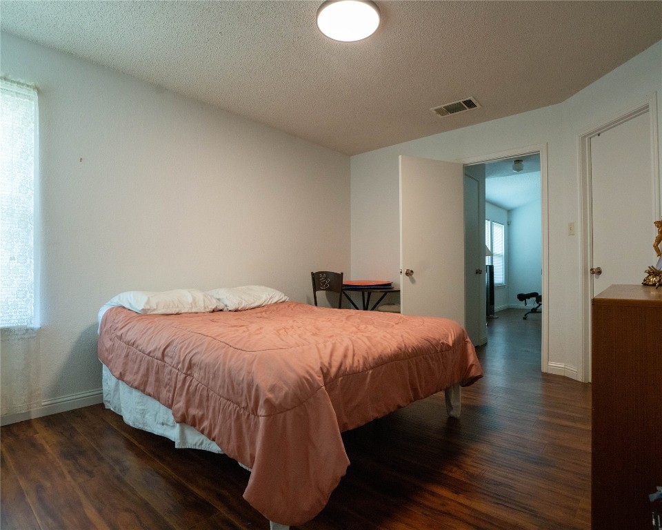 611 Penny Lane Cedar Park, TX 78613 - Photo 16 of 28 a bedroom with a bed and wooden floor