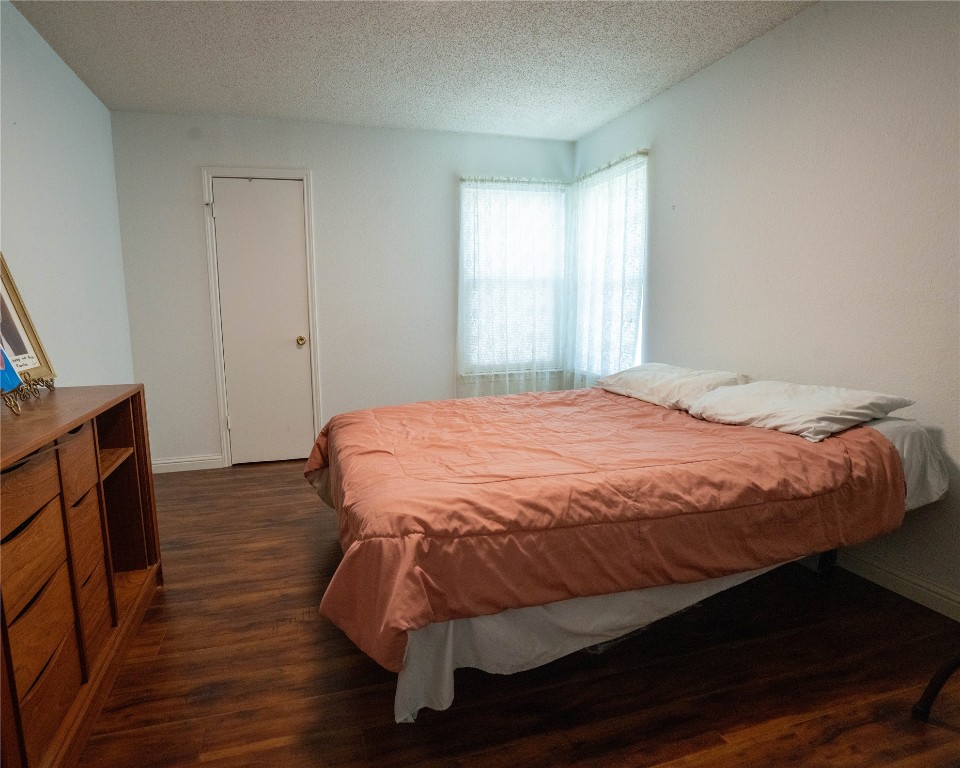 611 Penny Lane Cedar Park, TX 78613 - Photo 17 of 28 a large bed sitting in a bedroom next to a window