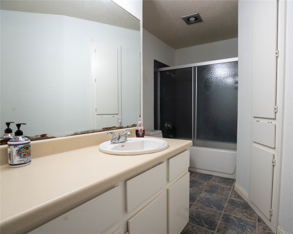 611 Penny Lane Cedar Park, TX 78613 - Photo 18 of 28 a bathroom with a sink and a mirror