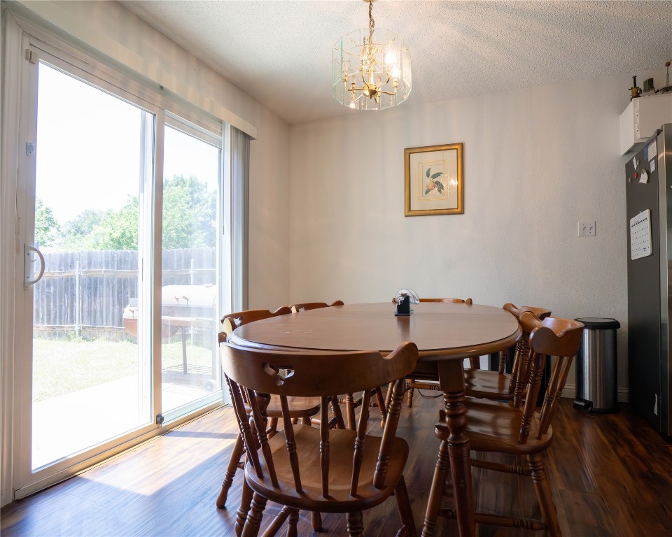 611 Penny Lane Cedar Park, TX 78613 - Photo 10 of 28 a view of a dining room with furniture window and wooden floor