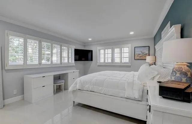 a spacious bedroom with a bed and a large window