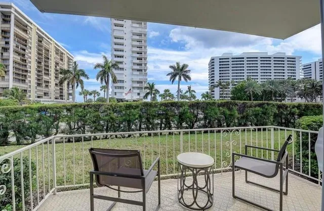 a view of a chairs and table in the balcony