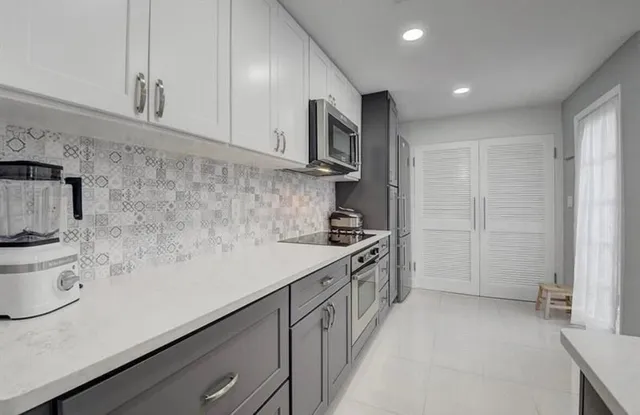 a kitchen with stainless steel appliances a sink a stove and a refrigerator