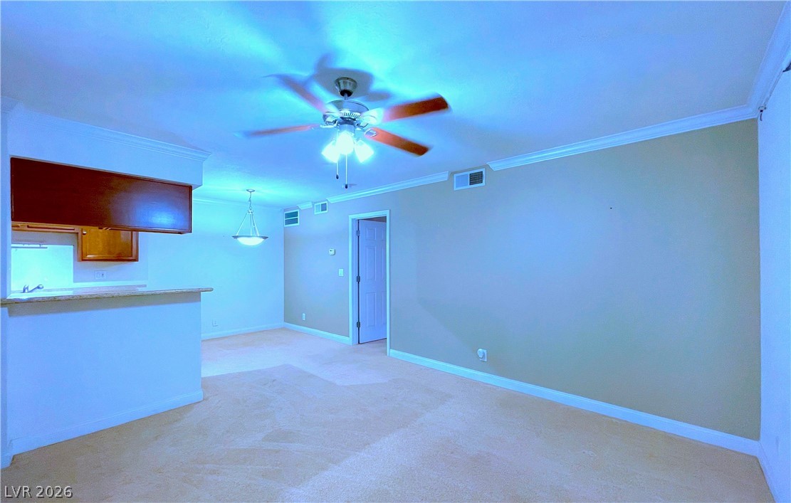 3135 South Mojave Road, Unit 156 Las Vegas, NV 89121 - Photo 3 of 18 A well-lit living area seamlessly connects to a compact kitchen bar, perfect for casual dining.