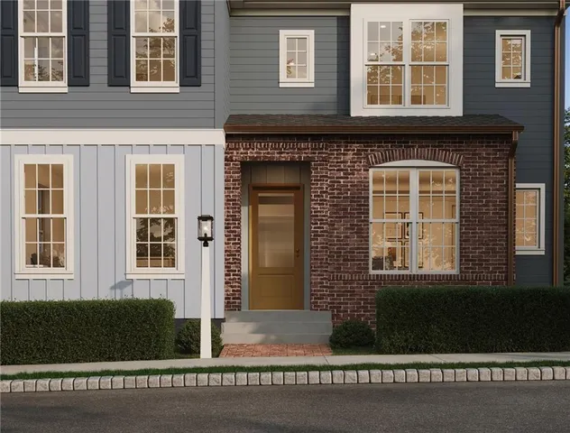 a front view of a house with a garden and yard