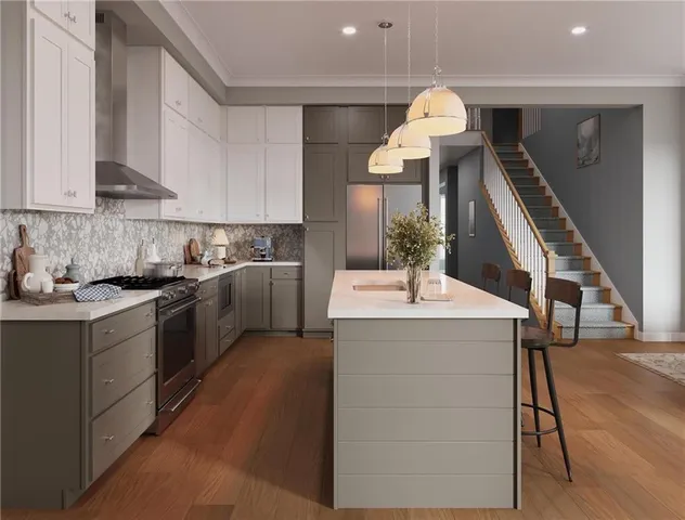 a kitchen with granite countertop a sink dishwasher a stove and a dining table with wooden floor