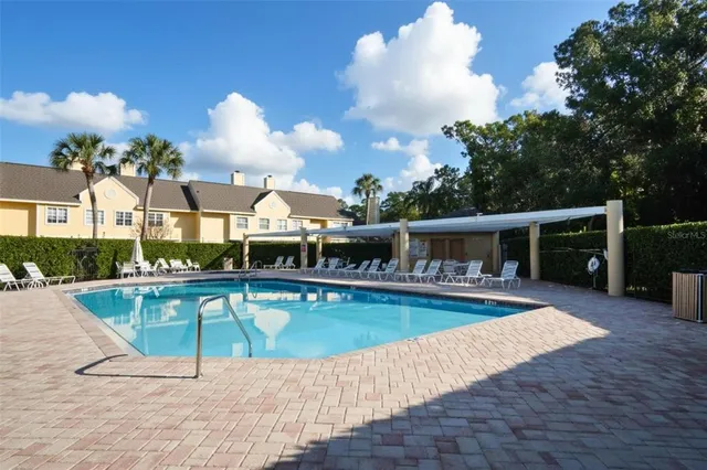a view of swimming pool with seating space