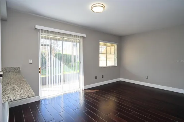 a kitchen with granite countertop a sink stove and cabinets