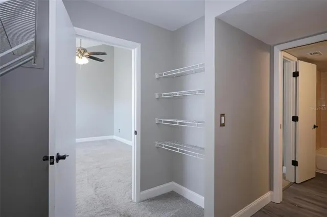 a view of staircase with white walls and empty room