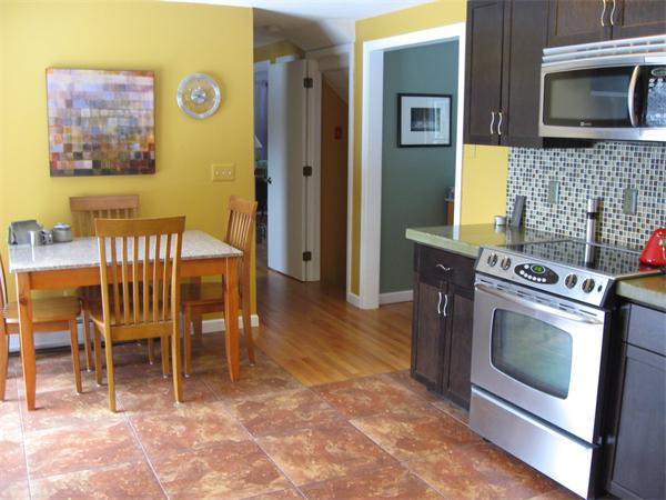 1244 Burts Pit Road Northampton, MA 01062 - Photo 3 of 30 a kitchen with stainless steel appliances granite countertop a stove top oven a sink a dining table and chairs